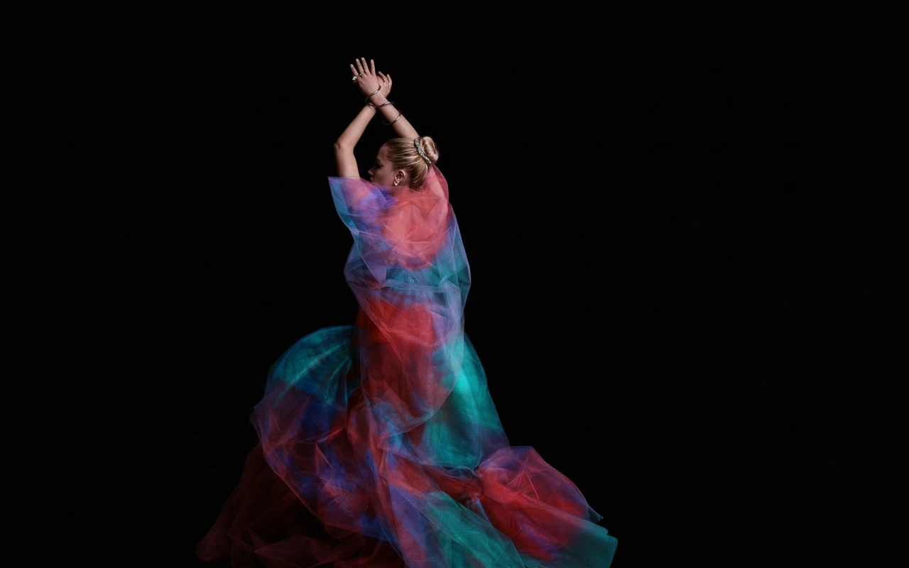 Woman against black background with her dress recolored to the fish’s vivid palette